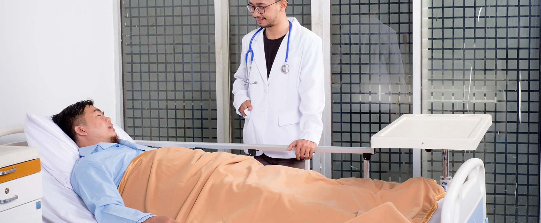 doctor standing near the injured patient. How Hearing Loss Puts You at Higher Risk for Other Injuries.