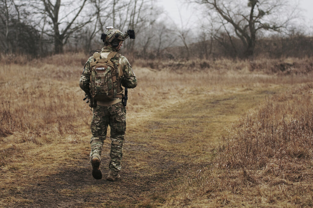 Soldier walking on the field. Military Hearing Loss Claims - 3M Earplug Lawsuit.